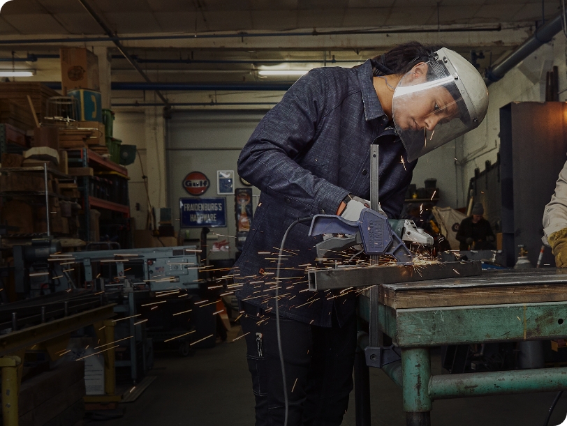 person wearing CORDURA® workwear working on metal