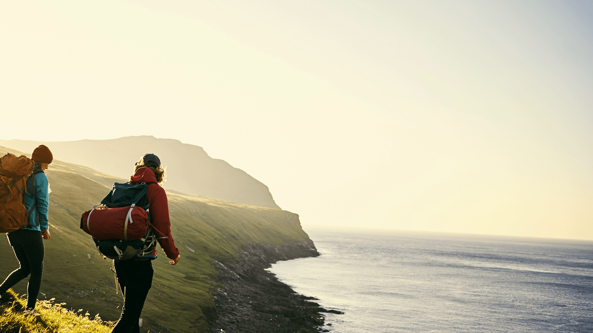 hikers exploring a beach side cliff